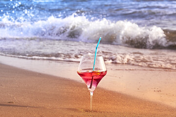 Wine glass with a cocktail by the sea.