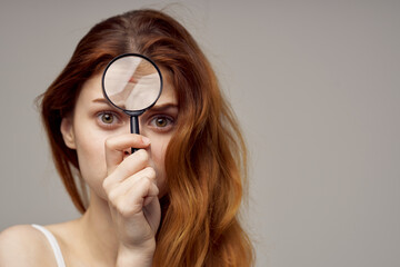 red-haired woman in a white t-shirt pimples on the face close-up