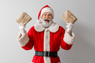 Happy Santa Claus with letters on grey background