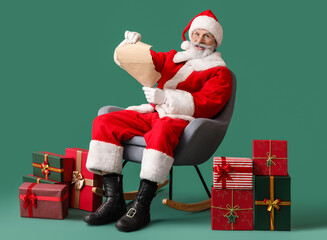 Santa Claus reading wish list on green background