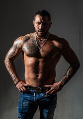 Obraz na płótnie Canvas Man with muscular body posing shirtless on black studio. Sexy hunk. Muscular bare torso. Six packs muscular chest.