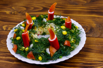 Salad Christmas wreath on a wooden table