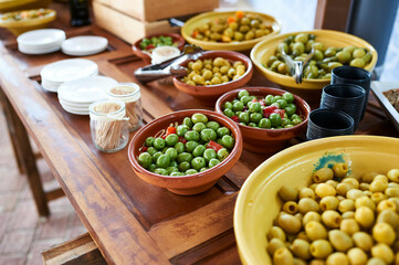 Bowl with assorted olives on table
