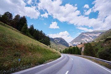 Asphalt road in Alps mountains. Trip concept.