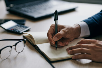 manager sitting at a desk in front of a laptop finance professional