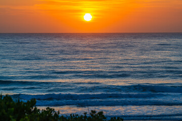 Orange sunrise with the sun over the sea