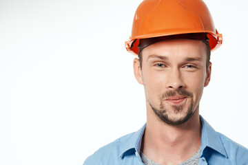 male builder in a blue shirt emotions professional light background