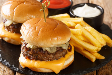 Butter Burgers made up of a pan seared buttery burger patty, a slice of cheese, onions cooked in...