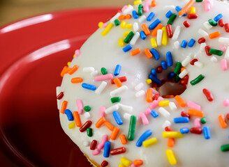 Fototapeta na wymiar Donut with sprinkles and white icing
