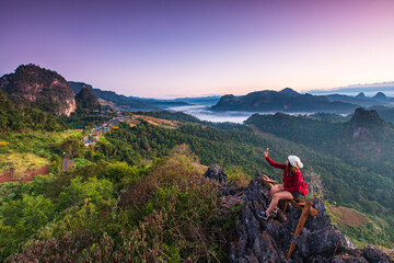 Young woman  in red  jacket touring on high  mountain, Ban Cha Bo, Mae Hong Son  province, Thailand.