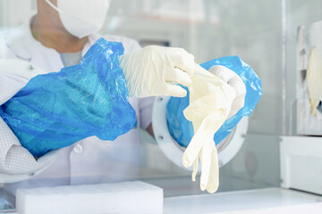 Close up to the rubber gloves on the asian medical staff is processing coronavirus or covid-19 test...