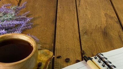 background with oak planks and pine planks painted white on the table a bunch of lavender and a wooden cup with coffee