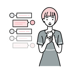 立ってスマートフォンで楽しくチャットで会話するエステ店員の女性