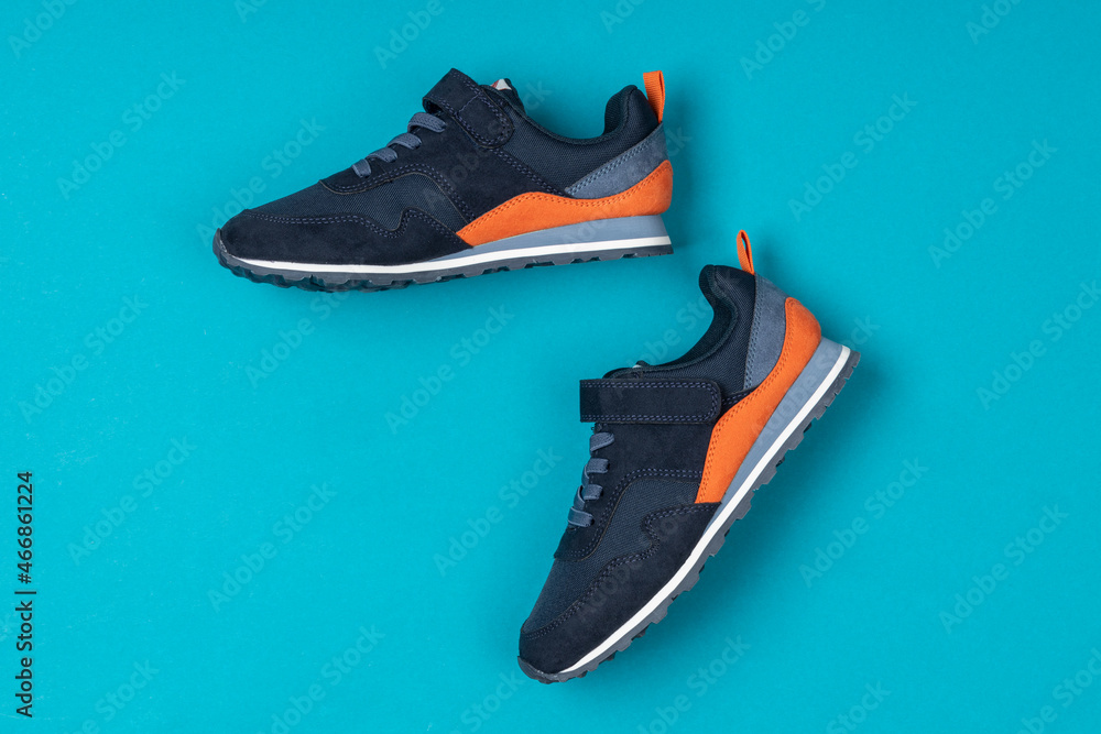 Wall mural pair of new sneakers, sport shoes on blue background. sport, running shoes