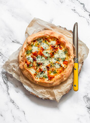 Pumpkin, leek, gorgonzola cheese  crunchy pie on a light background, top view. Delicious tapas,...