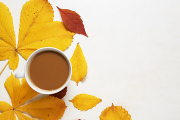 coffee on the table with autumn leaves