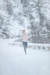 Fototapeta na wymiar The woman goes in for sports. The girl runs in the winter. High quality photo