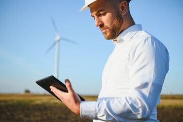 Electrical engineers working at wind turbine power generator station with laptop computer © Serhii