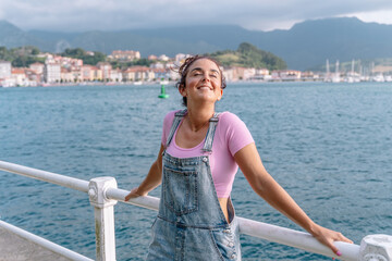 Horizontal view of woman traveling alone in summer. Caucasian woman with white smile on holidays in Asturias. Travel destination in Spain and summer concept.