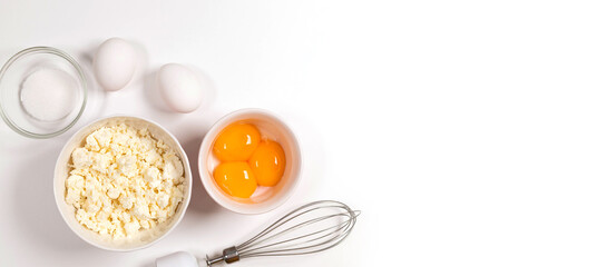 Baking utensils and cooking ingredients for tarts, cookies, dough and pastry. Flat lay with eggs, flour, sugar, cottage cheese