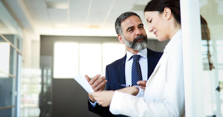 Happy business colleagues in modern office smiling and talking