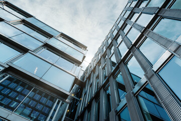 Obraz premium Looking Up Blue Modern Office Building. Background of Modern Glass Building Skyscrapers