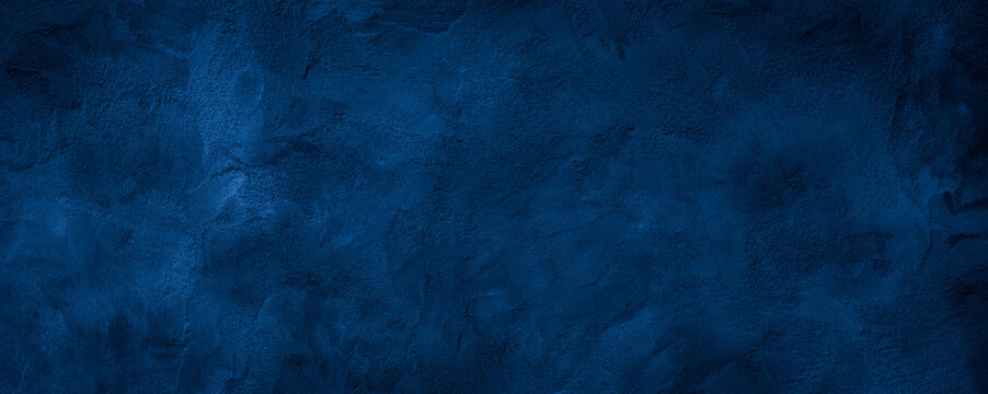 Dark blue rough grainy stone or concrete wall texture background