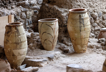  Recovered ancient pottery in prehistoric town of Akrotiri, excavation site of a Minoan Bronze Age settlement on the Greek island of Santorini - obrazy, fototapety, plakaty