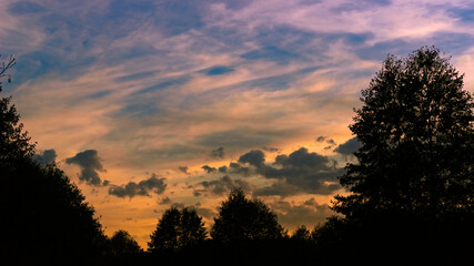 Sunset with clouds and trees.