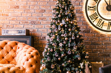 a leather sofa in the loft room on the eve of the new year, in the back pane a big Christmas tree with toys