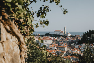 Panoramic view of the old historical coastal Slovenia town Piran with typical tower near the...