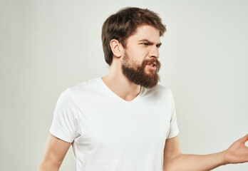 emotional man in a white t-shirt hand gestures anger close-up