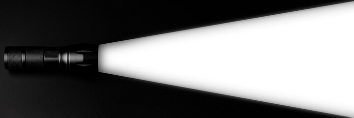 flashlight illuminates a white area on black background. creative ideas innovative free space for...