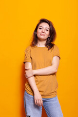 Obraz premium Positive adult standing over isolated background. Cheerful woman posing with confidence, feeling casual while looking at camera. Stylish person smiling and having relaxed expression