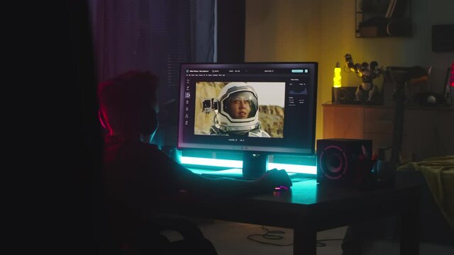 Teenager retouching photo at night