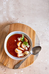 Tomato soup bowl on the wooden try. Perfect vegetarian dish. Top view