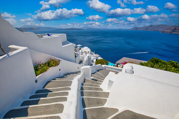Oia town on Santorini island, Greece. Traditional famous white blue houses stairs, pathways under sunny blue sky Caldera, Aegean sea. Beautiful summer landscape, sea view, luxury travel vacation