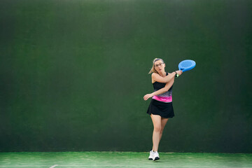 Female athlete playing padel in gym