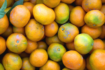 Wooden crate filled with fresh tangerines. Top view.