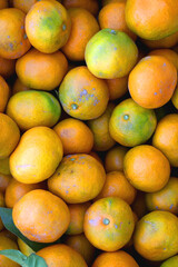 Wooden crate filled with fresh tangerines. Top view.