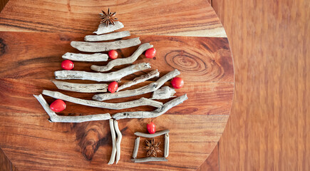 Christmas tree made of dry wood over wooden background, copy space, xmas and new year symbol, decoration. 