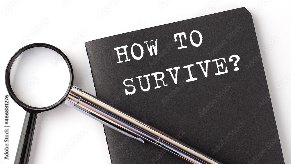Poster how to survive business concept, magnifier with white text message on black notebook