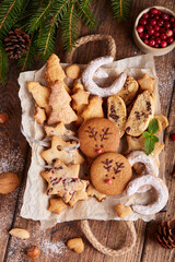Box with variety of Christmas cookies: gingerbread deers, stars with cranberries, Christmas trees with brown sugar, Biscotti cantucci with oranges, almonds and chocolate, horseshoe with sugar powder