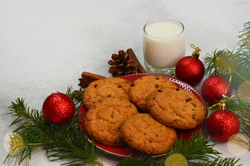 traditional Christmas drink eggnog cocktail and homemade chocolate cookies, a glass of fresh milk and sweets for santa, tradition on merry christmas Eve