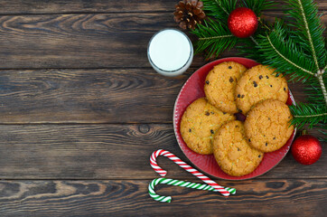 traditional Christmas drink eggnog cocktail and homemade chocolate cookies, a glass of fresh milk and sweets for santa, tradition on merry christmas Eve.