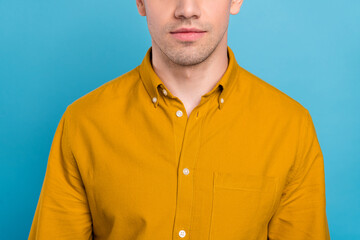 Cropped photo of serious healthy guy smooth facial skin wear yellow shirt isolated blue color background