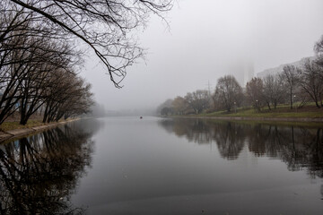 river embankment and autumn park on a cloudy autumn day 