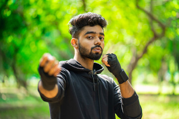 Young man doing boxing exercise outdoor