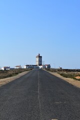 
A street and a lighthouse in a town called Peniche in Portugal