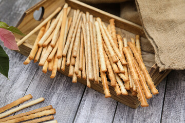 Grissini crispy italian bread sticks on a rustic background